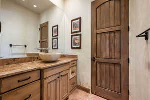 Bathroom featuring vanity, light tile patterned floors, and recessed lighting
