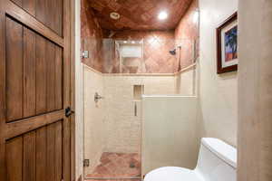 Bathroom featuring toilet and a stall shower