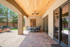 View of patio featuring outdoor dining area and a ceiling fan