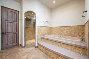 Bathroom featuring a garden tub, a stall shower, and recessed lighting
