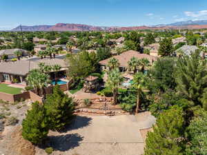 Aerial view of residential area with a mountainous background and a pool area