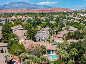 Aerial perspective of suburban area with a mountainous background and a pool area