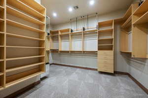 Spacious closet with light colored carpet