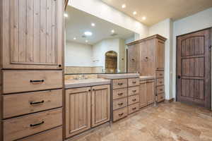Bathroom with double vanity and recessed lighting