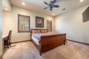 Bedroom featuring light colored carpet, recessed lighting, a ceiling fan, and an office area