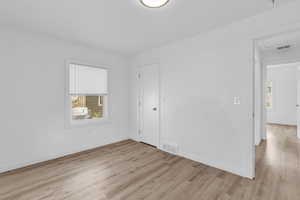 Empty room with light wood-type flooring