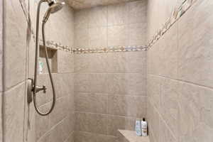 Full bathroom featuring tiled shower