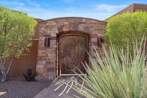 Doorway to property featuring stone siding