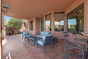 View of patio with an outdoor living space with a fireplace