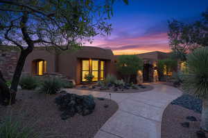 View of front of property featuring stucco siding and stone siding