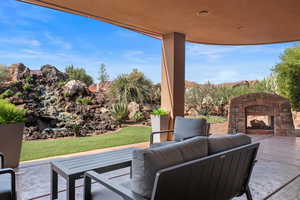 View of patio with an outdoor living space with a fireplace