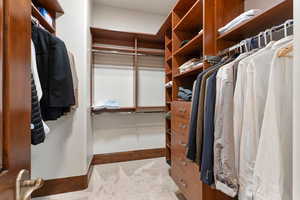 Spacious closet featuring light carpet