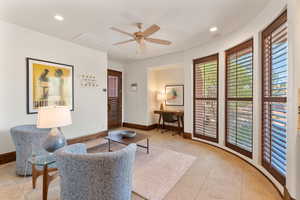 Living area featuring recessed lighting, a desk, light tile patterned floors, and a ceiling fan