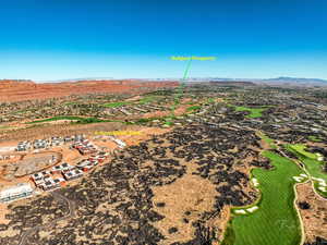 Bird's eye view of a mountainous background and a local golf course
