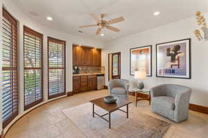 Living area featuring recessed lighting, light tile patterned flooring, and ceiling fan