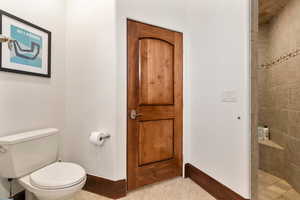 Full bath featuring a tile shower and tile patterned floors