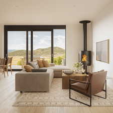 Living area with a mountain view, a wood stove, and light wood finished floors