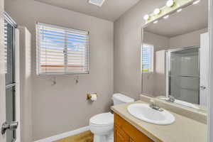Bathroom with vanity, a stall shower, and light tile patterned flooring