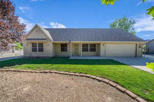 View of front of house featuring stucco siding, a front lawn, concrete driveway, an attached garage, and a porch