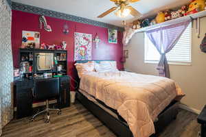 Bedroom featuring wood finished floors and a ceiling fan
