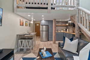Living room featuring light wood finished floors and recessed lighting