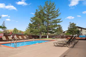 Community pool with a patio and a mountain view