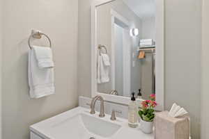Bathroom with a textured wall and vanity