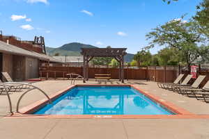 Community pool with pergola picnic area and mountain view