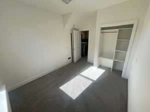 Unfurnished bedroom with carpet and a closet