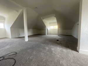 Additional living space with carpet and lofted ceiling