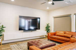 Living room featuring wood finished floors, recessed lighting, and ceiling fan