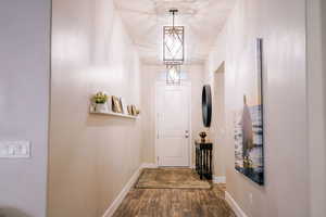 Doorway featuring wood finished floors and baseboards