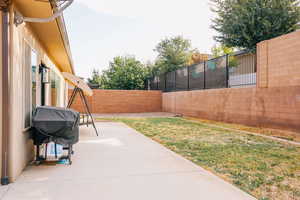 Fenced backyard with a patio
