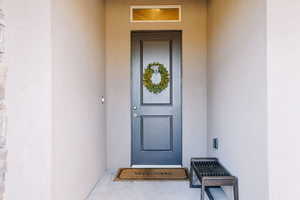 Entrance to property featuring stucco siding