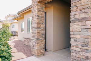 View of home's exterior with stucco siding and stone siding