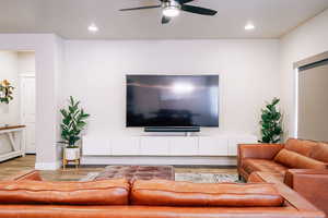 Living room with wood finished floors, recessed lighting, and ceiling fan