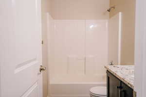 Bathroom featuring vanity and shower / washtub combination