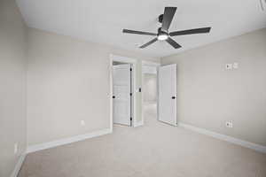 Unfurnished bedroom with carpet flooring and a ceiling fan
