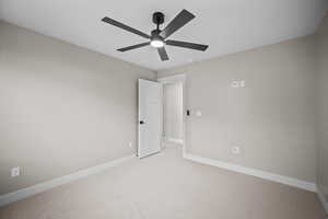 Empty room with carpet floors and baseboards