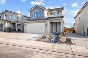 Traditional-style home with board and batten siding, driveway, and an attached garage