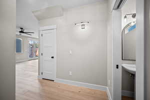 Hall with light wood-type flooring and french doors