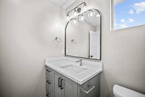 Half bath featuring vanity and toilet