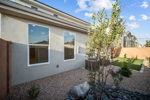 View of home's exterior with stucco siding and a central air condition unit