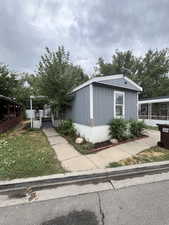 View of side of property with a wooden deck