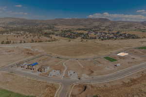 Aerial view of property and surrounding area with a mountain backdrop and rural landscape