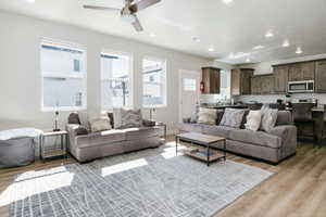 Living room featuring recessed lighting, light wood-style flooring, and ceiling fan