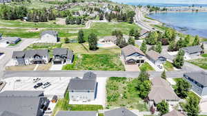 Aerial perspective of suburban area featuring a nearby body of water