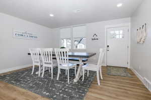 Dining area featuring light wood-type flooring and recessed lighting