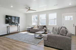 Living area with light wood-style flooring, recessed lighting, and a ceiling fan