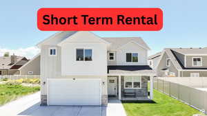 View of front of house with stone siding, board and batten siding, an attached garage, covered porch, and roof with shingles
